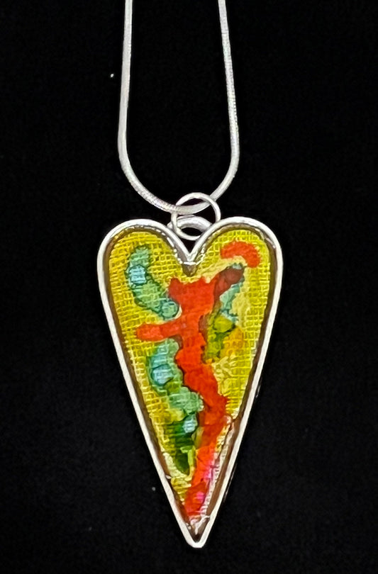 heart shaped silver pendant necklace with green, red, and aqua artwork