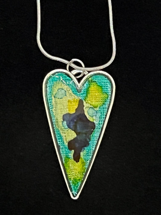 heart shaped silver pendant necklace with aqua, green, and blue artwork